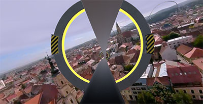 View from the air over the old town, flying toward a ring-shaped gate on the tour’s path