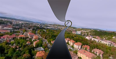 The tour’s path curving ahead as a ribbon above the rooftops